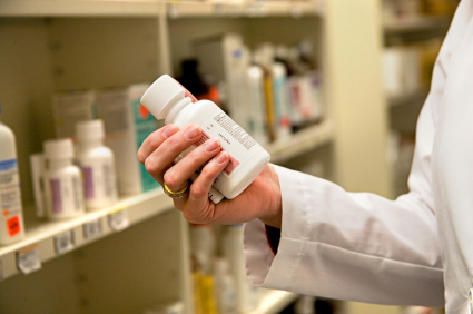 Pharmaceutical holding a medicine bottle.