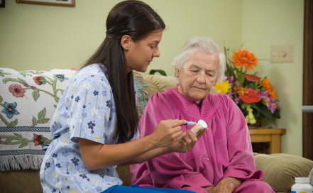 Caregiver reading over prescription medicine information with the patient.