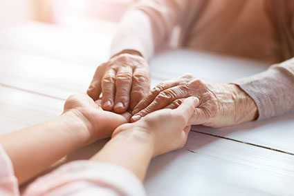hospice support team holding hands