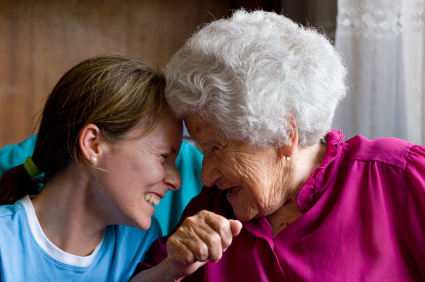 Elderly patient and younger woman looking face to face.