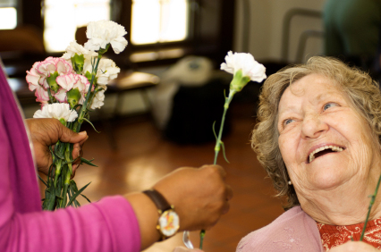Patient smiling when receiving a flower.